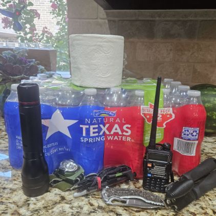Emergency supplies including water, flashlight, and radio